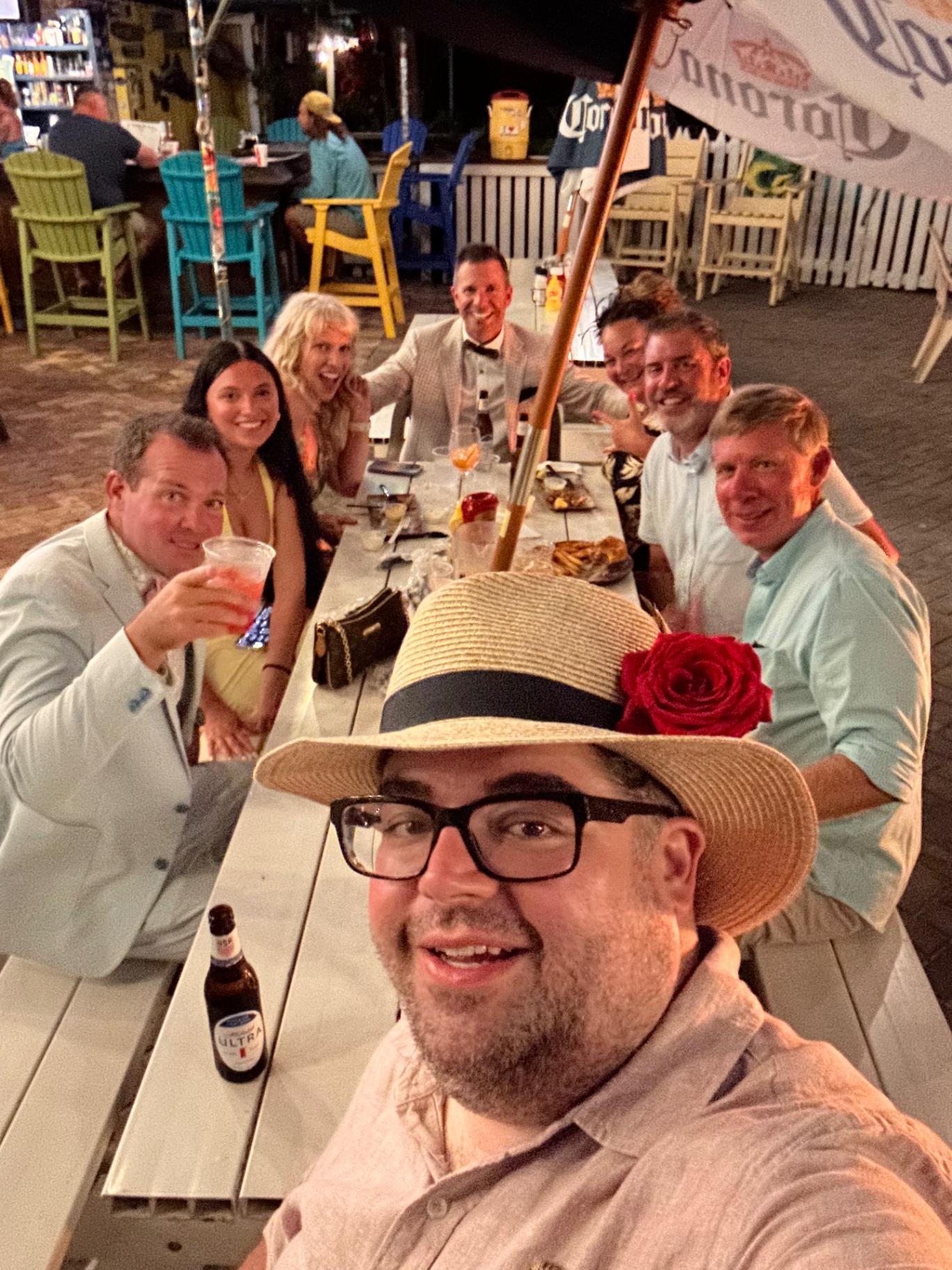 A long table of guests raises their glasses during the Derby party