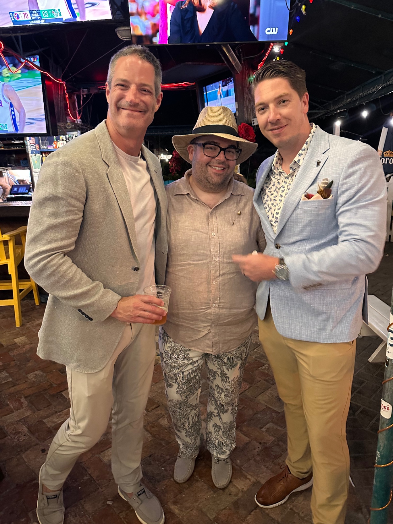 Three guests share a laugh at the Derby party