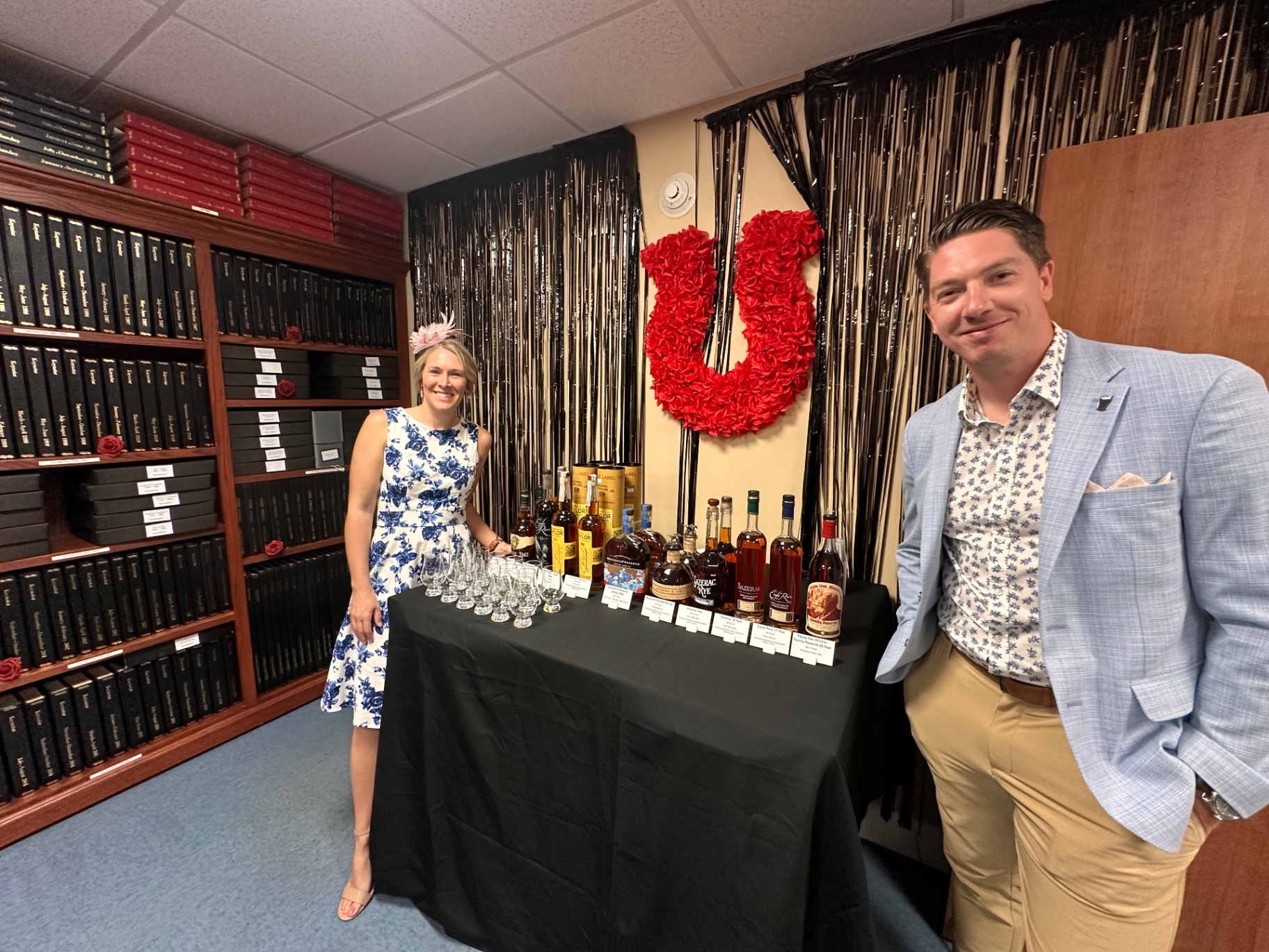 A bourbon tasting lineup of bottles and tasting glasses set up in the research library