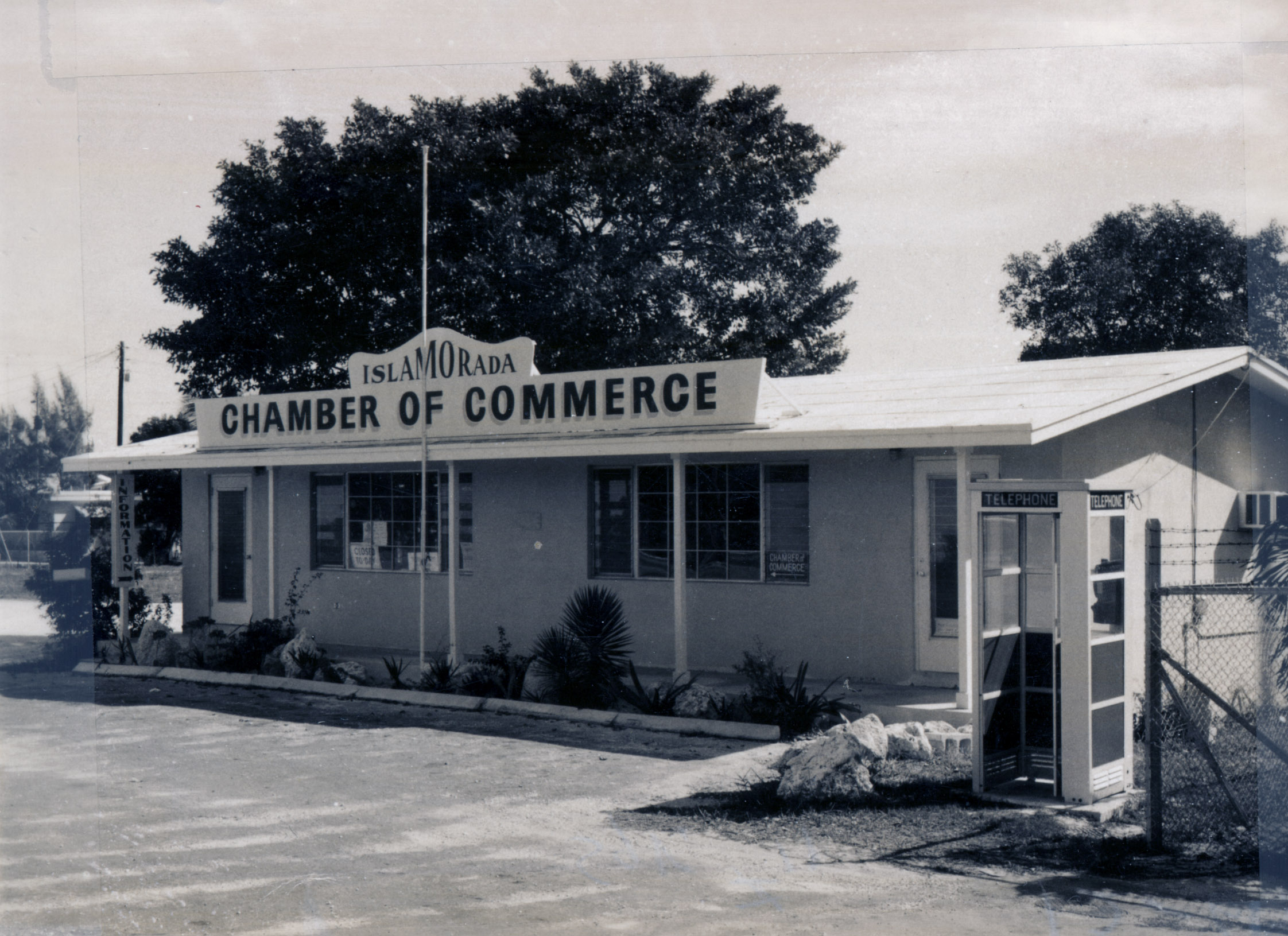 The Islamorada Chamber of Commerce building with a telephone booth outside, about 1965
