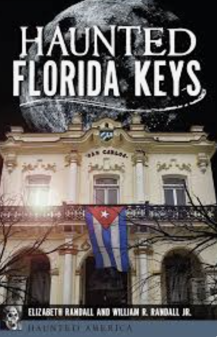 Book cover of Haunted Florida Keys — a moonlit San Carlos building draped with a Cuban flag, from the Haunted America series