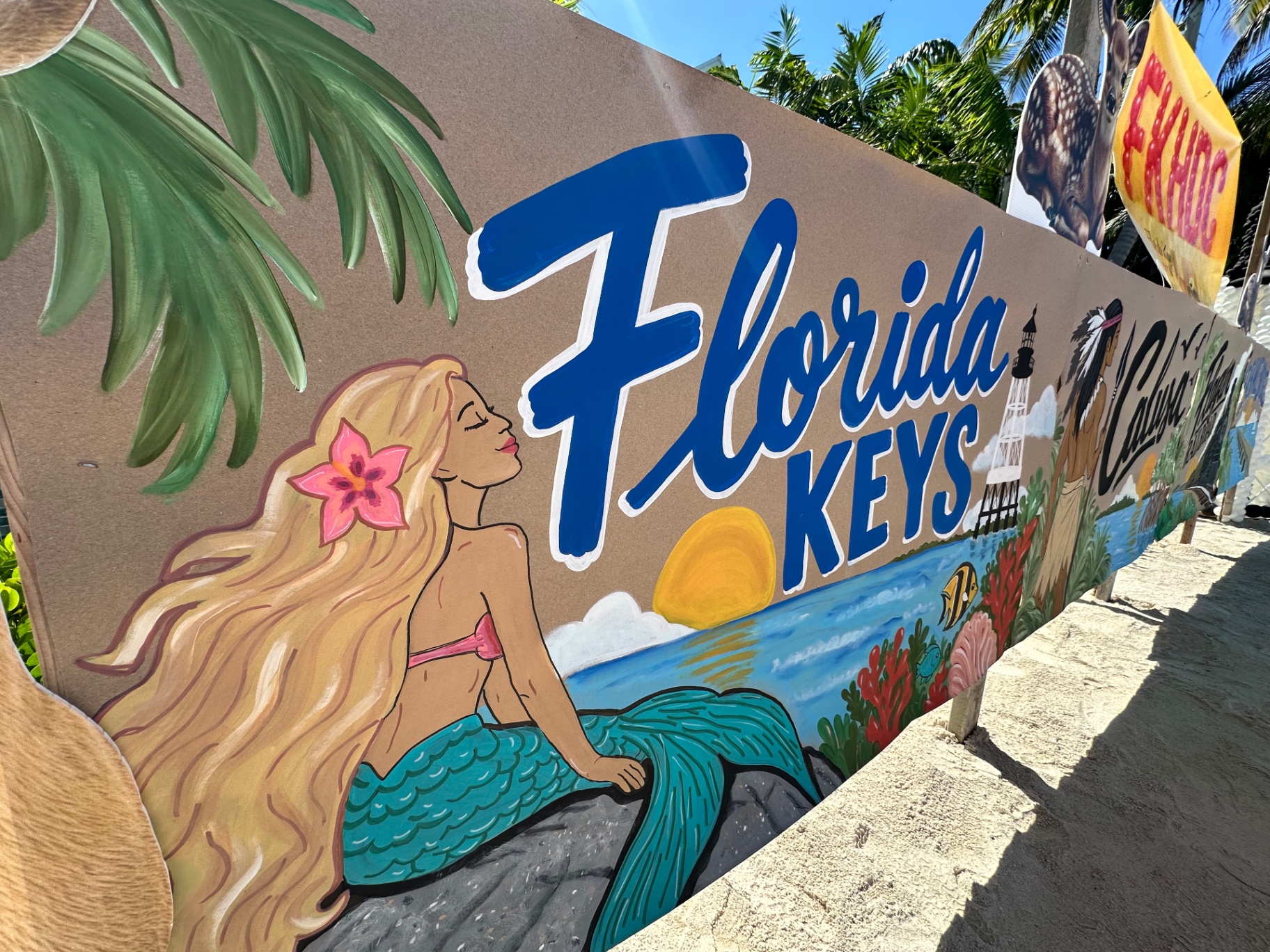 Hand-painted Florida Keys artwork with a mermaid and a lighthouse lined the Center's hole at the Conch Scramble