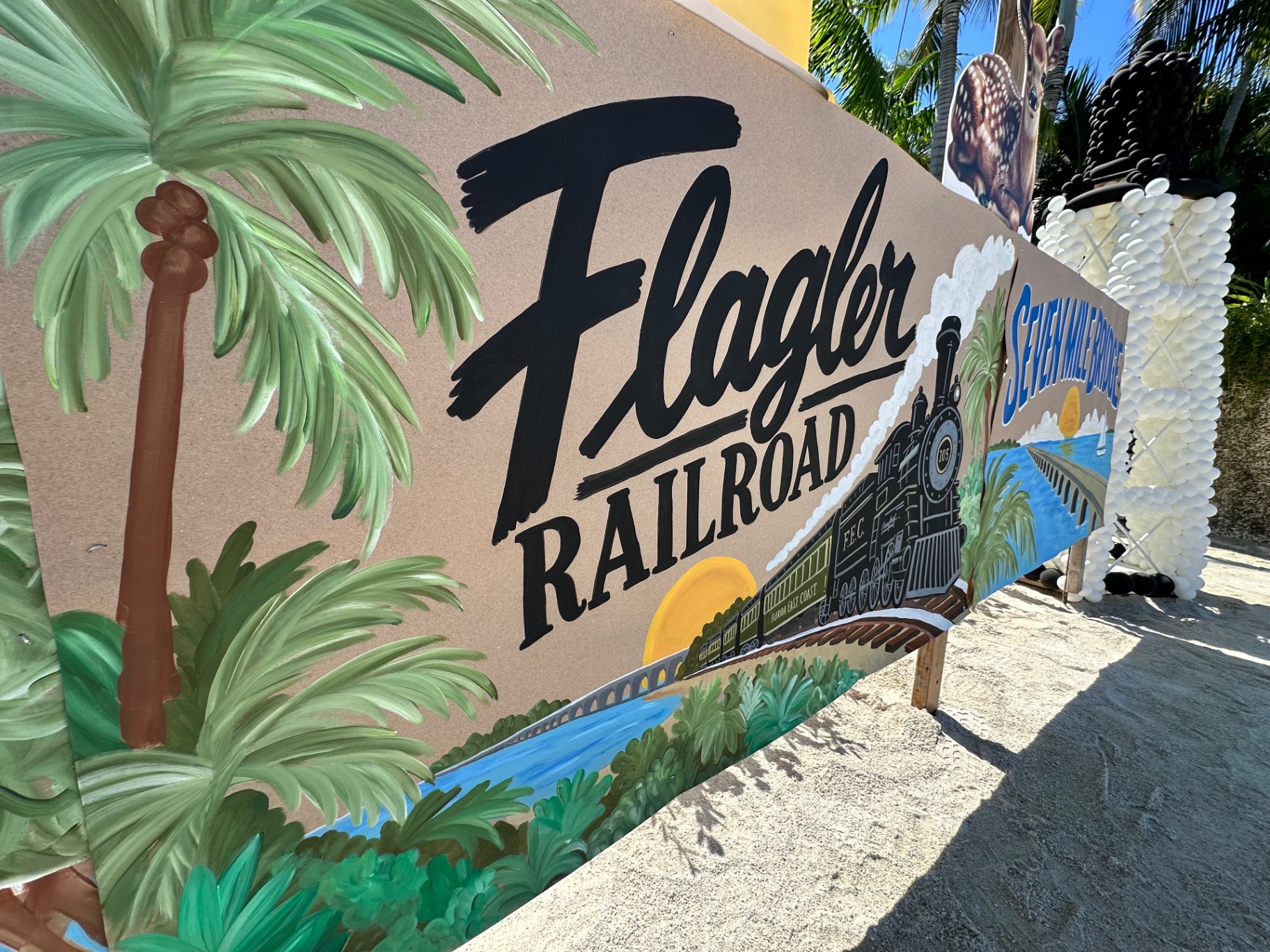 A painted Flagler Railroad sign with a steam locomotive decorated the Center's Conch Scramble hole
